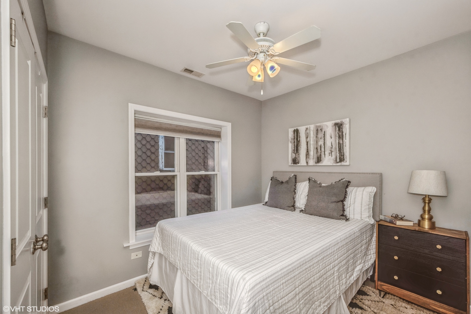 1750 West Rascher Avenue, Unit 2 Chicago, IL 60640 - Photo 7 of 11 a bedroom with a bed and a chandelier