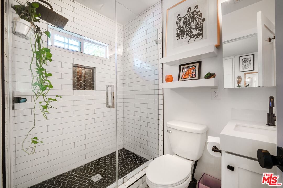 11202 Kling Street North Hollywood, CA 91602 - Photo 11 of 18 a white toilet sitting next to a bathroom sink