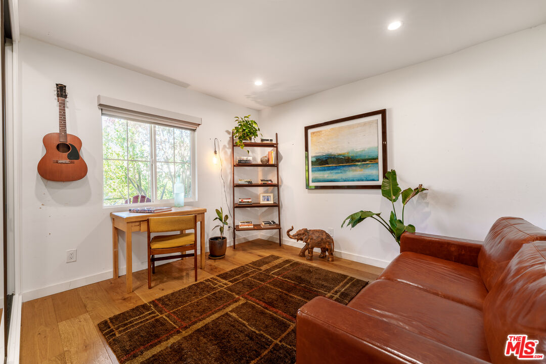 11202 Kling Street North Hollywood, CA 91602 - Photo 12 of 18 a living room with furniture a window and a bookshelf
