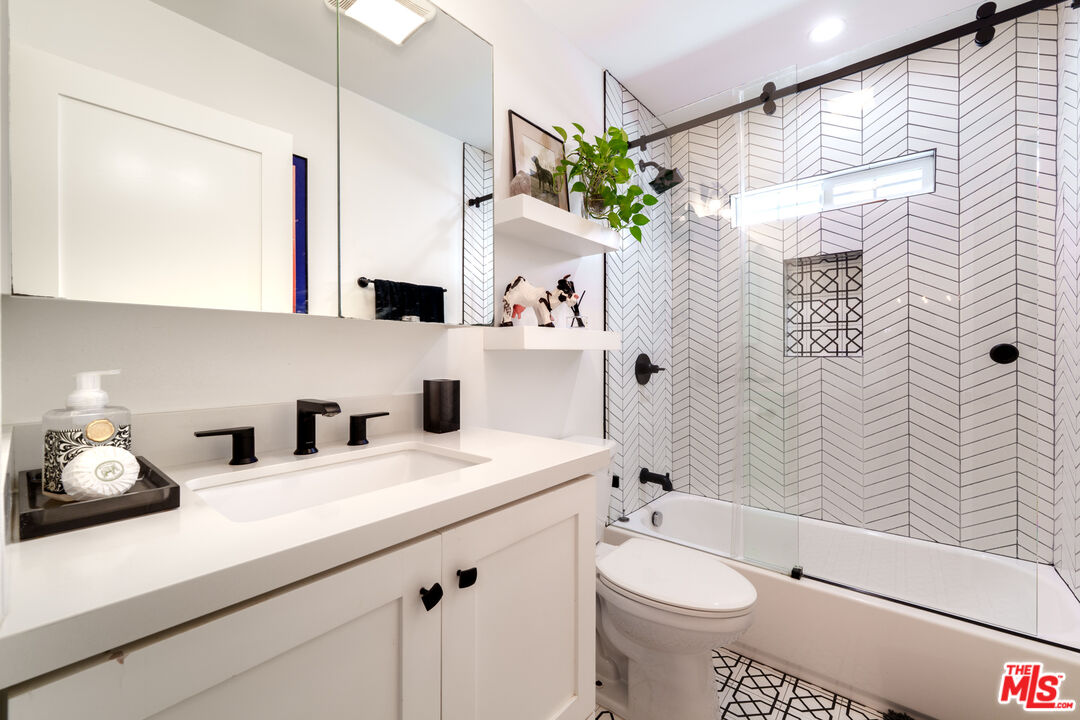 11202 Kling Street North Hollywood, CA 91602 - Photo 13 of 18 a bathroom with a sink a toilet and shower