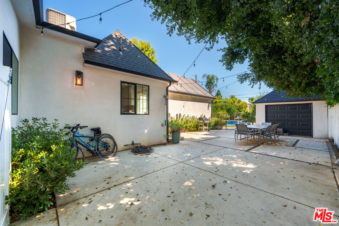 11202 Kling Street North Hollywood, CA 91602 - Photo 17 of 18 a view of a backyard with table and chairs and potted plants
