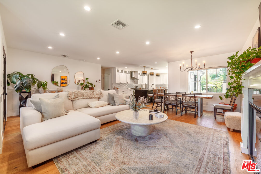 11202 Kling Street North Hollywood, CA 91602 - Photo 4 of 18 a living room with furniture kitchen view and a potted plant