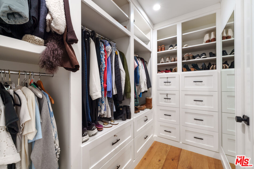 11202 Kling Street North Hollywood, CA 91602 - Photo 9 of 18 a view of walk in closet with clothes and shoes