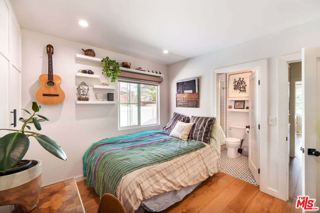 11202 Kling Street North Hollywood, CA 91602 - Photo 10 of 18 a bedroom with a bed and wooden floor