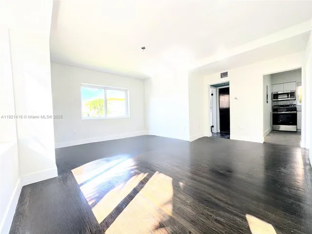 a view of a room window and wooden floor