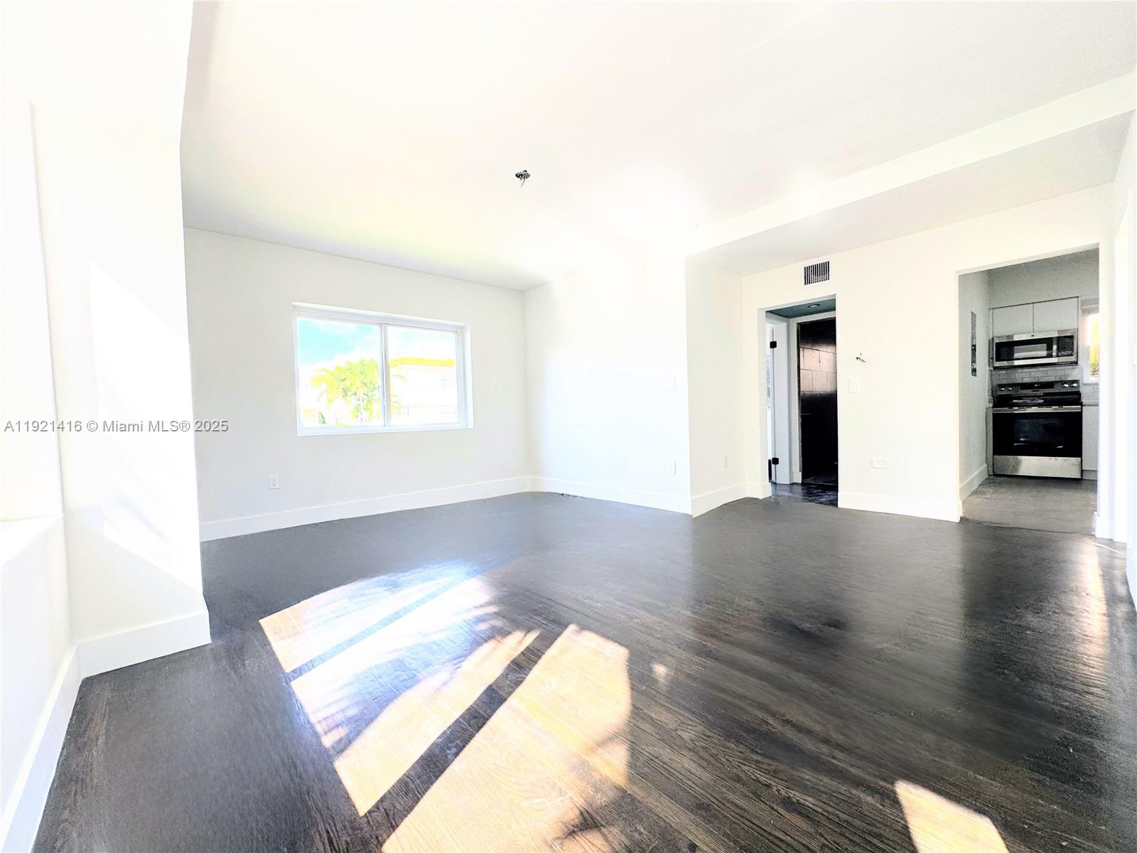 7325 Byron Avenue, Unit 8 Miami Beach, FL 33141 - Photo 8 of 16 a view of a room window and wooden floor