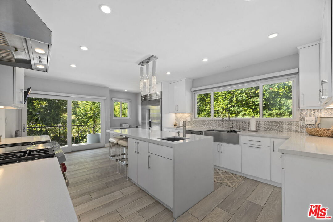 641 Walther Way Los Angeles, CA 90049 - Photo 11 of 53 a kitchen with a sink stove and cabinets