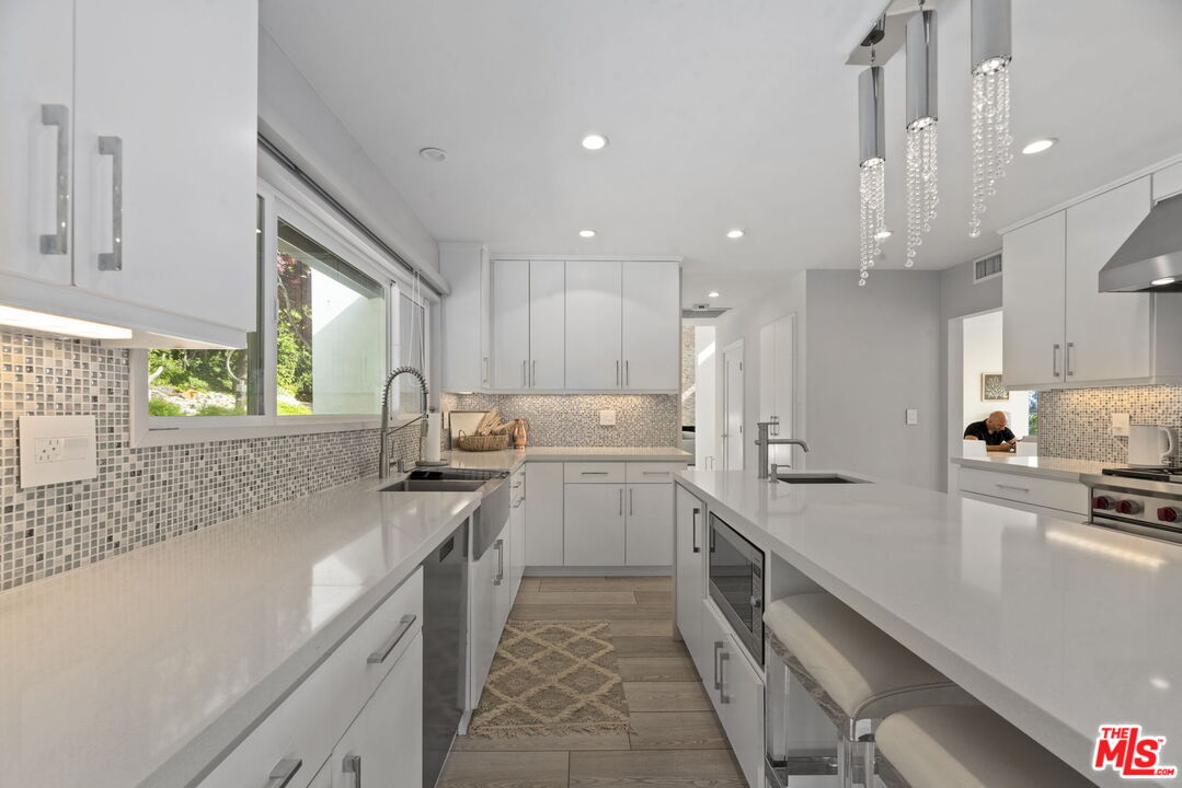641 Walther Way Los Angeles, CA 90049 - Photo 13 of 53 a kitchen with a sink stove and cabinets
