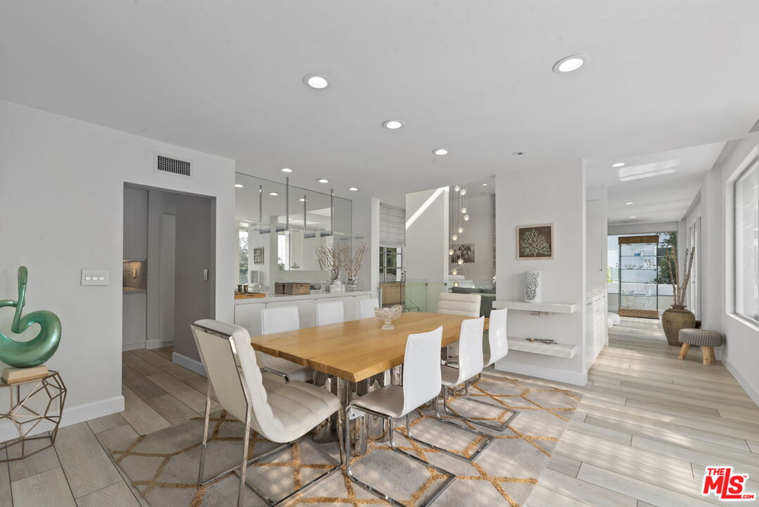 641 Walther Way Los Angeles, CA 90049 - Photo 14 of 53 a large kitchen with a table and chairs