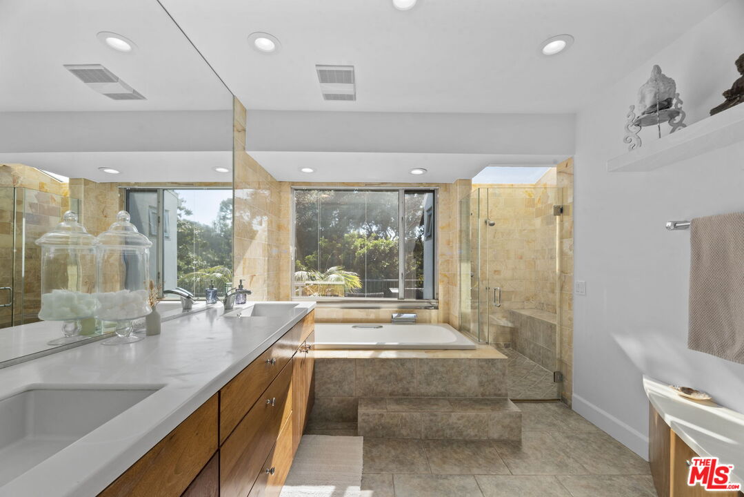 641 Walther Way Los Angeles, CA 90049 - Photo 27 of 53 a large bathroom with a large tub and shower