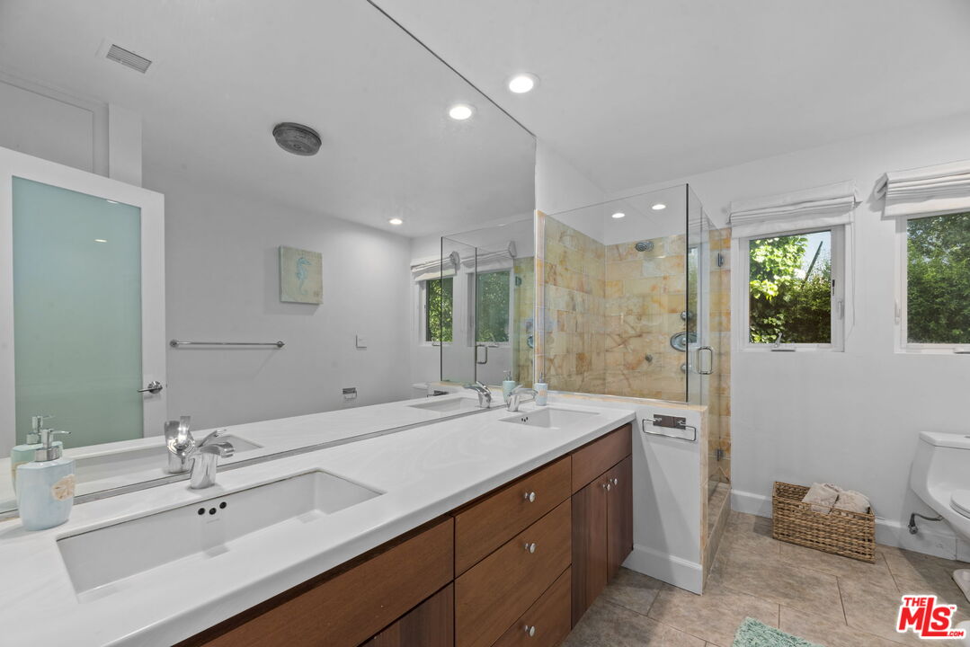 641 Walther Way Los Angeles, CA 90049 - Photo 33 of 53 a bathroom with a double vanity sink mirror and double