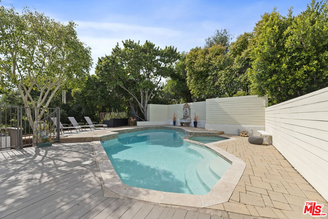 641 Walther Way Los Angeles, CA 90049 - Photo 38 of 53 a view of a swimming pool with sitting area