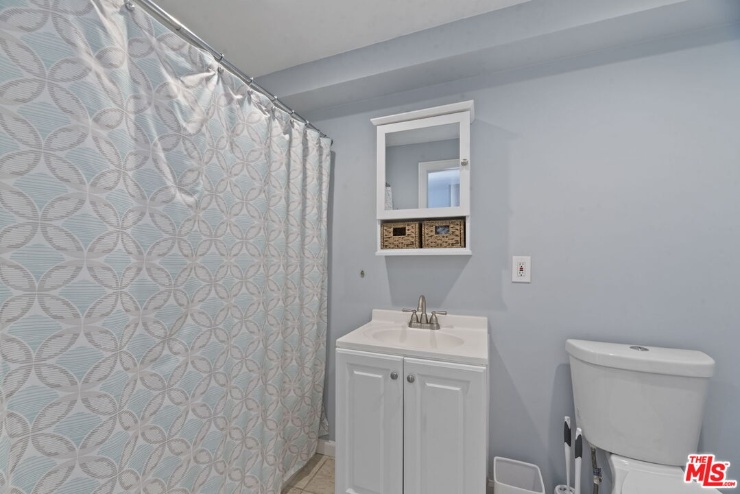 641 Walther Way Los Angeles, CA 90049 - Photo 50 of 53 a bathroom with a sink a toilet and shower