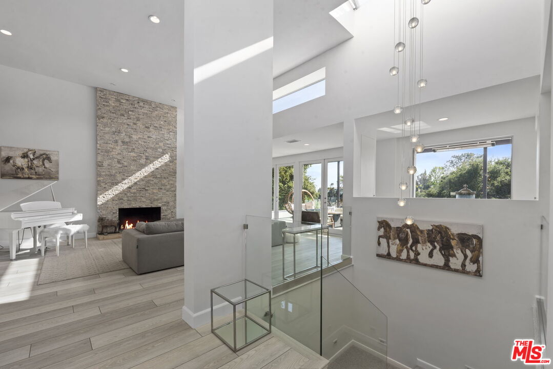 641 Walther Way Los Angeles, CA 90049 - Photo 5 of 53 a kitchen with stainless steel appliances kitchen island granite countertop a refrigerator and microwave