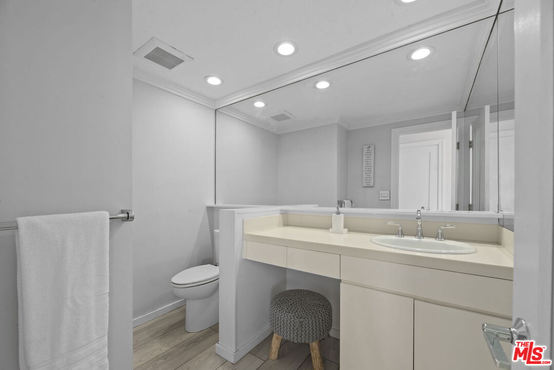 641 Walther Way Los Angeles, CA 90049 - Photo 51 of 53 a bathroom with a sink a toilet and a mirror