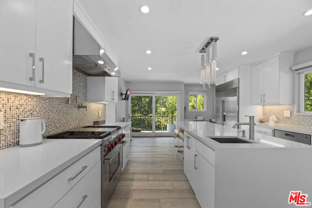 641 Walther Way Los Angeles, CA 90049 - Photo 10 of 53 a kitchen with a sink stove top oven and cabinets