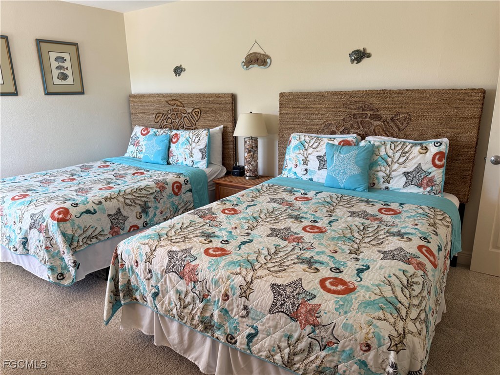 5117 Sea Bell Road, Unit G205 Sanibel, FL 33957 - Photo 18 of 31 a bedroom with two beds and painting on the wall