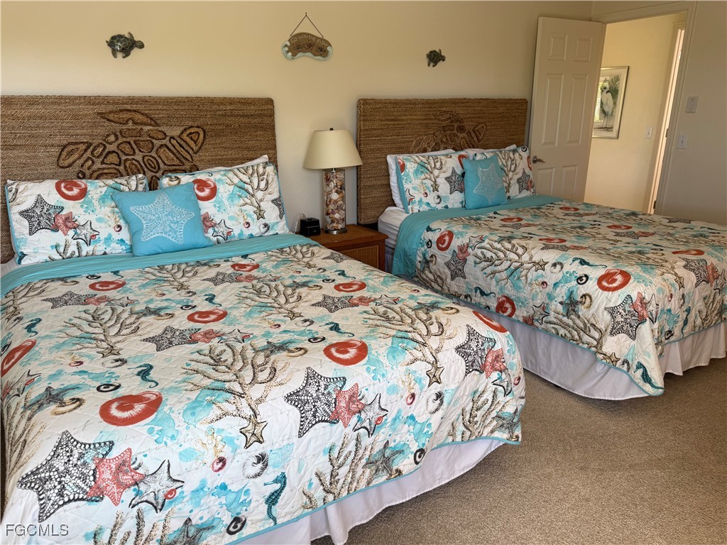 5117 Sea Bell Road, Unit G205 Sanibel, FL 33957 - Photo 20 of 31 a bedroom with two beds and a painting on the wall
