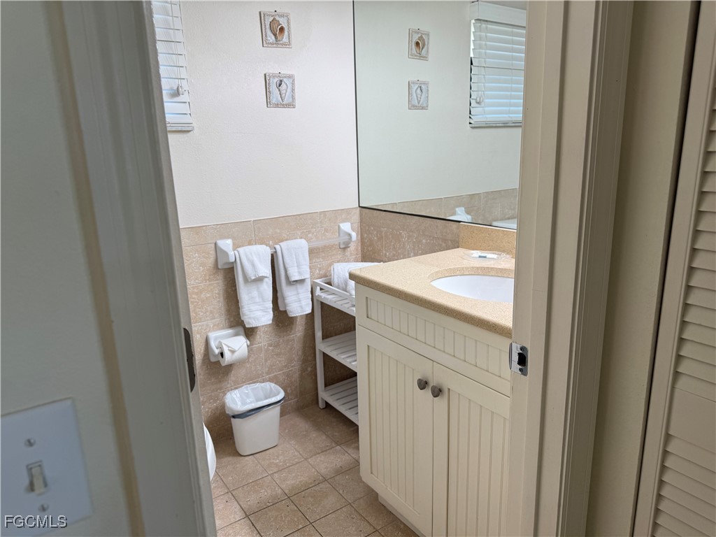 5117 Sea Bell Road, Unit G205 Sanibel, FL 33957 - Photo 21 of 31 a bathroom with a granite countertop sink mirror and toilet