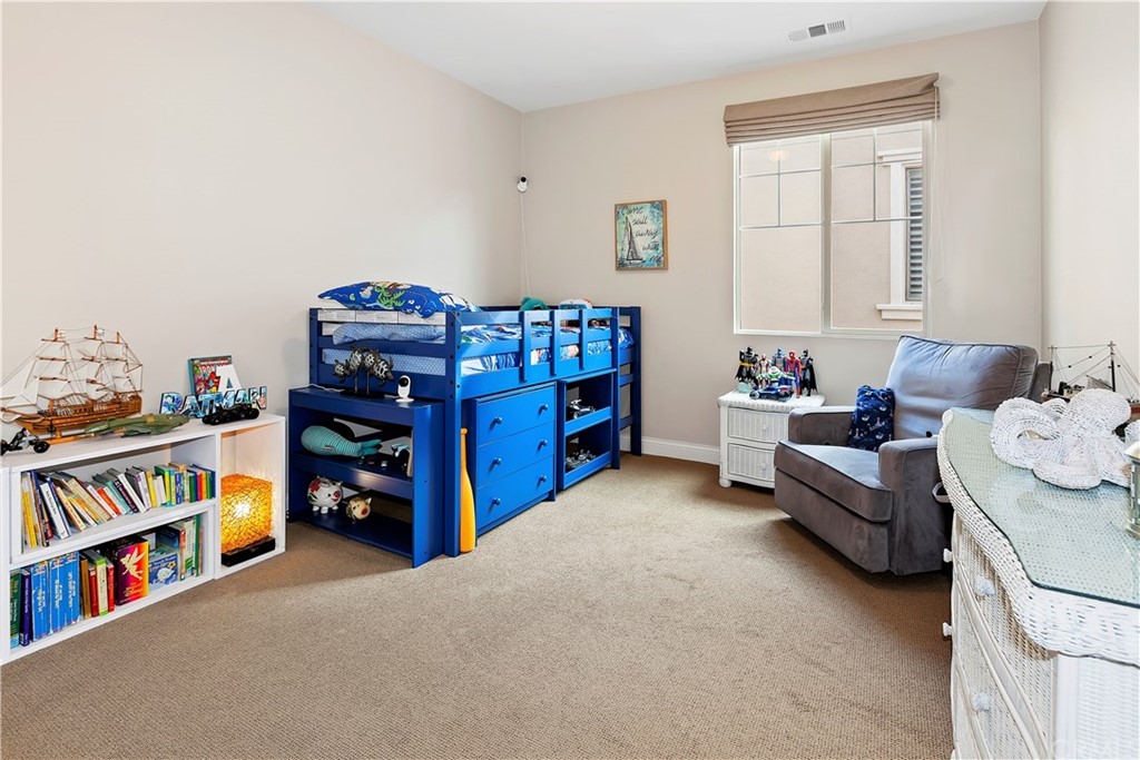 95 Shadowbrook Irvine, CA 92604 - Photo 9 of 23 a living room with lots of furniture and baby crib