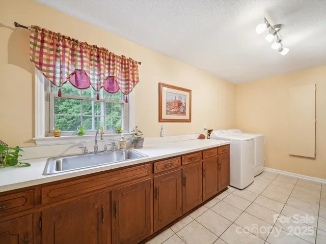 a spacious bathroom with a double vanity sink mirror and window