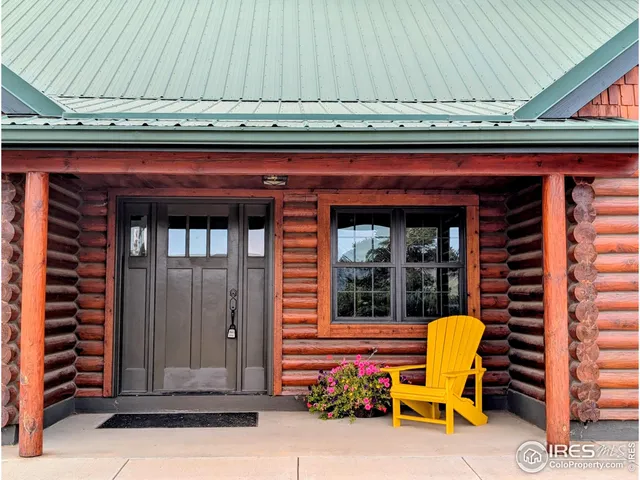 a view of a door with a chair and potted plant