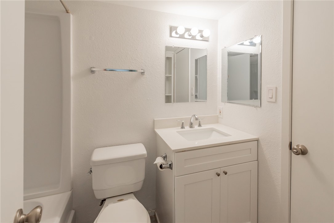2500 Burleson Road, Unit 614 Austin, TX 78741 - Photo 12 of 20 a bathroom with a toilet sink and mirror