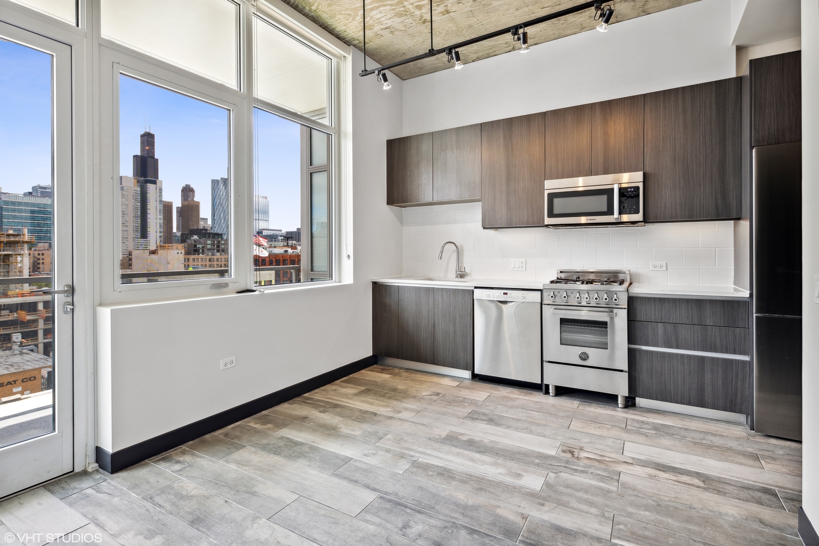 171 North Aberdeen Street, Unit 809 Chicago, IL 60607 - Photo 2 of 20 a kitchen with stainless steel appliances a microwave and stove