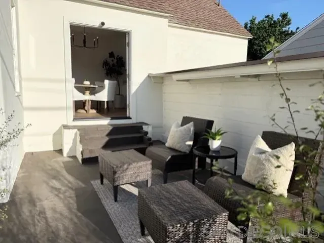 a couple of chairs sitting in patio of a house