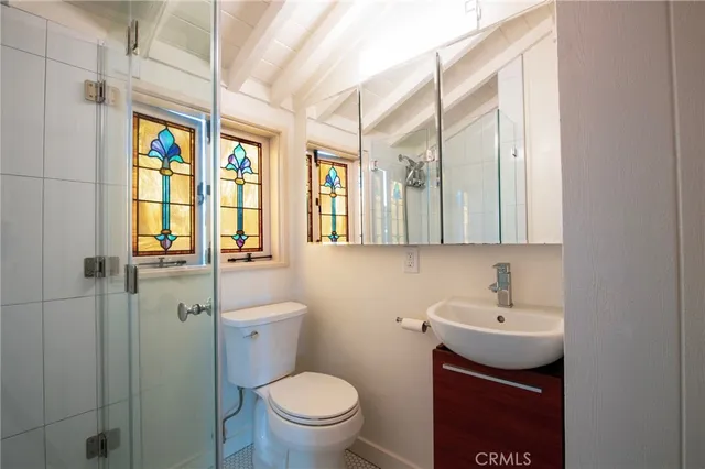 a bathroom with a toilet a sink and mirror
