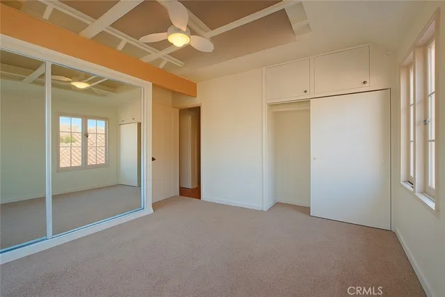 an empty room with windows and closet