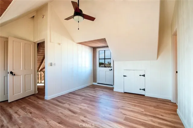 a view of a livingroom with wooden floor and a ceiling fan