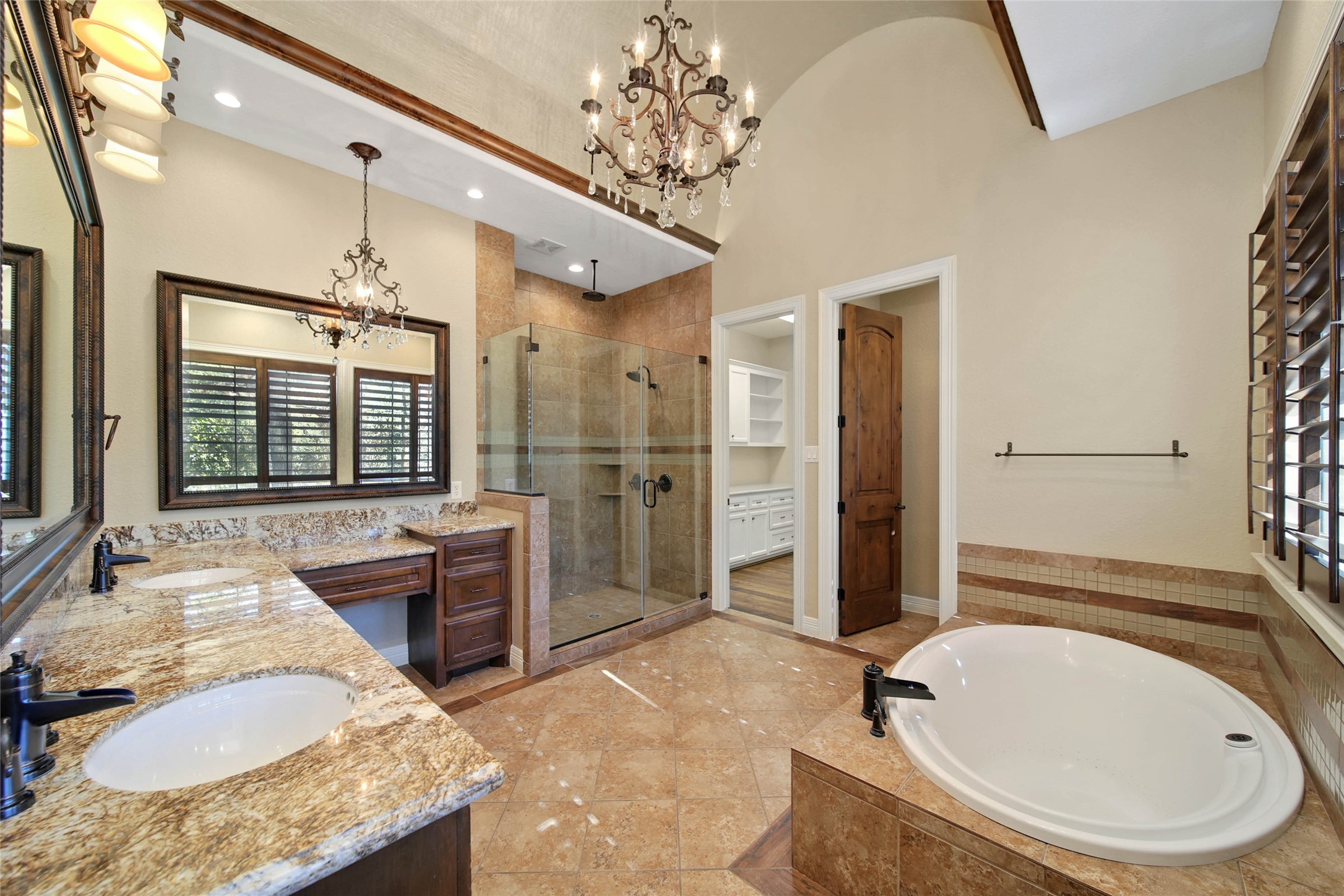 6803 Star Ledge Court Spring, TX 77389 - Photo 24 of 48 Second Master Bath with garden tub, frameless glass shower, custom cabinetry with dual sinks, framed mirror, and custom closet