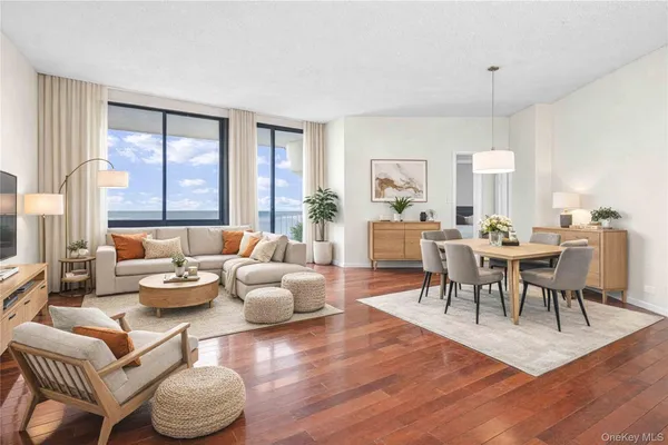 a living room with furniture dining table and a large window