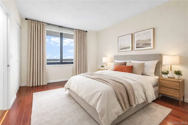 a bedroom with a large bed and a window