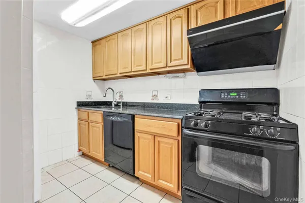 a kitchen with stainless steel appliances a stove a microwave and cabinets