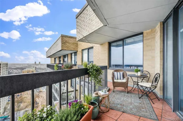 a balcony view with a seating space