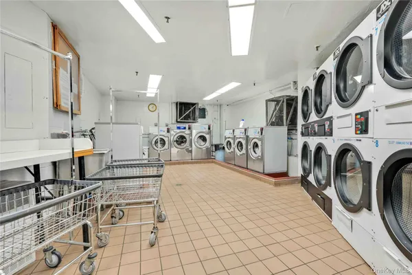 a view of a kitchen with furniture and a washer dryer