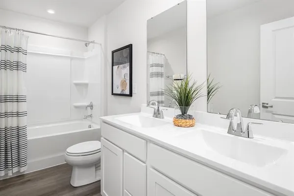 a bathroom with a sink a toilet and a bathtub