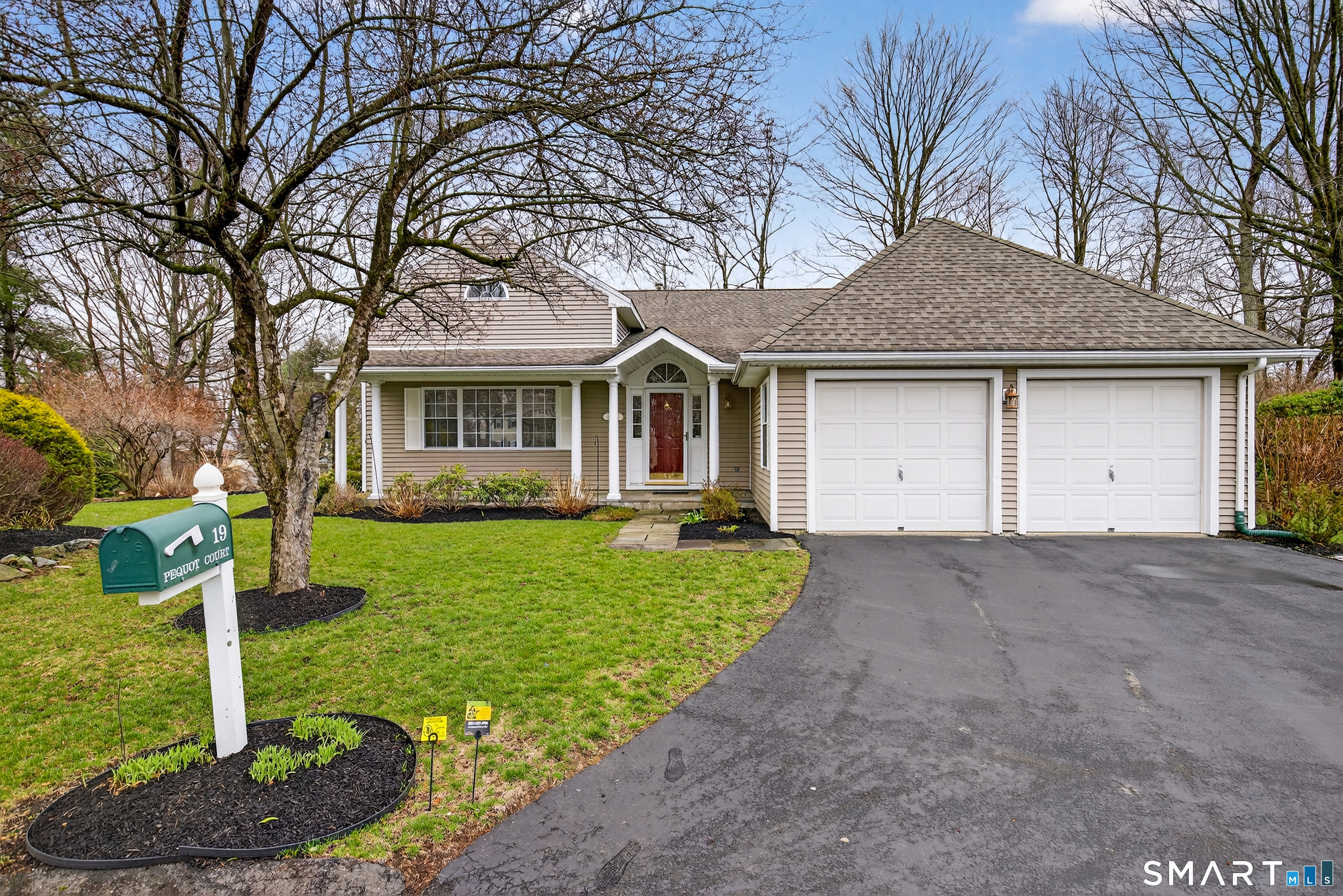 19 Pequot Court, Unit 19 Monroe, CT 06468 - Photo 1 of 1 a front view of a house with a yard and garage
