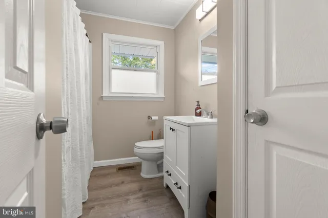 a bathroom with a toilet sink and a window