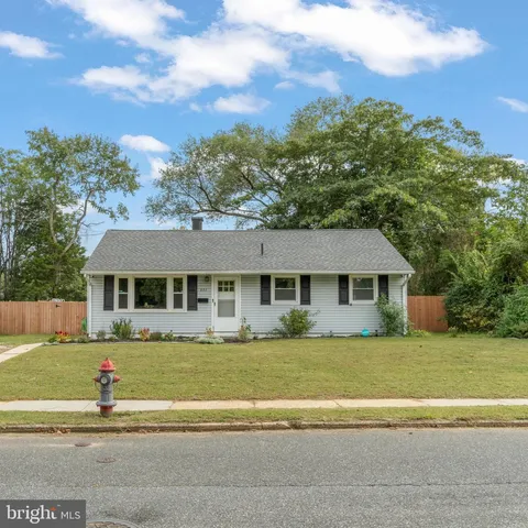 a front view of a house with a garden and yard