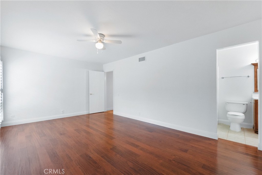 2172 Belhaven Avenue Simi Valley, CA 93063 - Photo 11 of 24 a view of a room with wooden floor and a ceiling fan