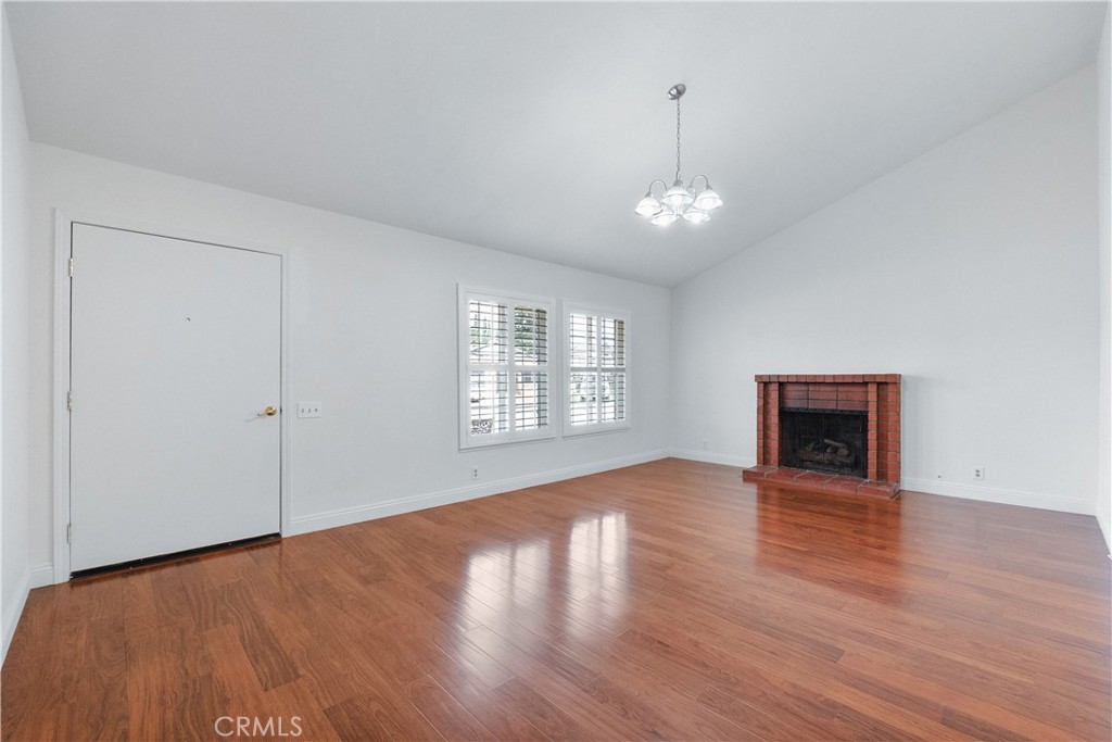2172 Belhaven Avenue Simi Valley, CA 93063 - Photo 2 of 24 an empty room with wooden floor chandelier and windows