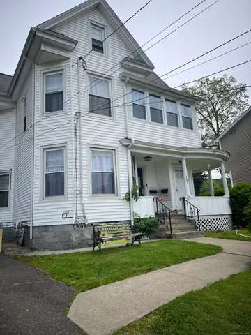a view of a brick house with a yard