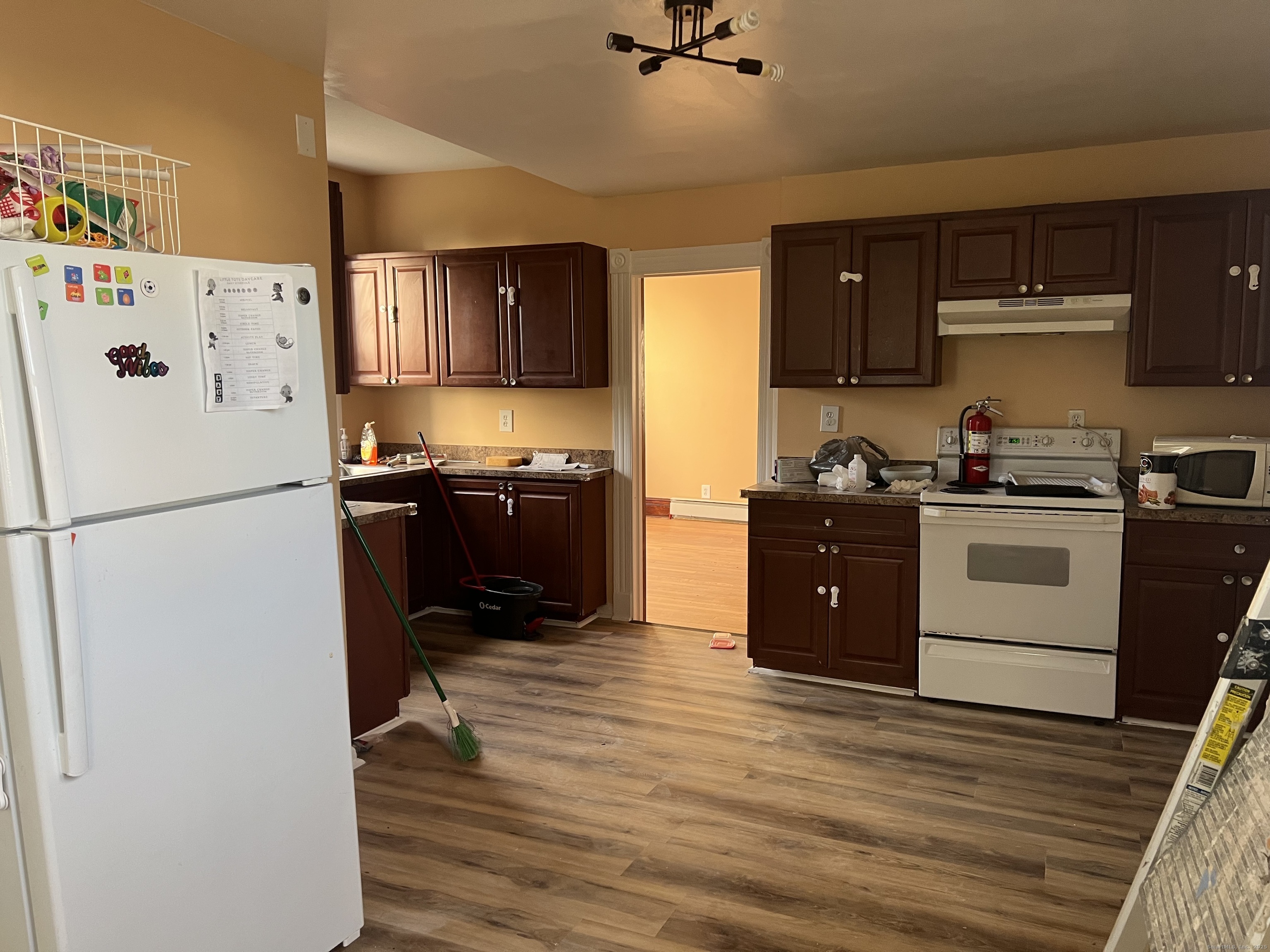 181 High Street, Unit 2 Naugatuck, CT 06770 - Photo 11 of 14 a kitchen with a refrigerator a stove a sink and a microwave