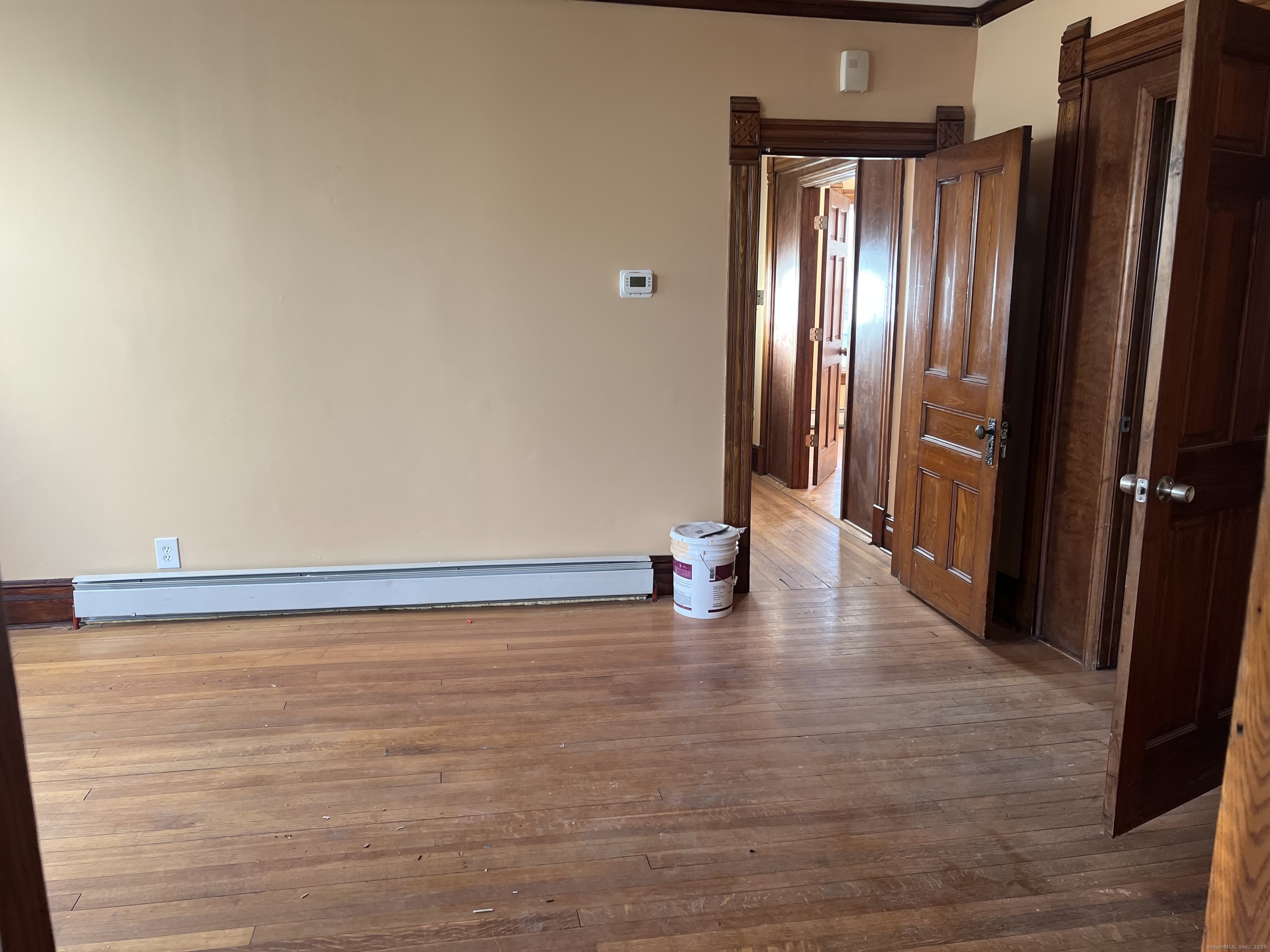 181 High Street, Unit 2 Naugatuck, CT 06770 - Photo 12 of 14 a view of an empty room with wooden floor and a window