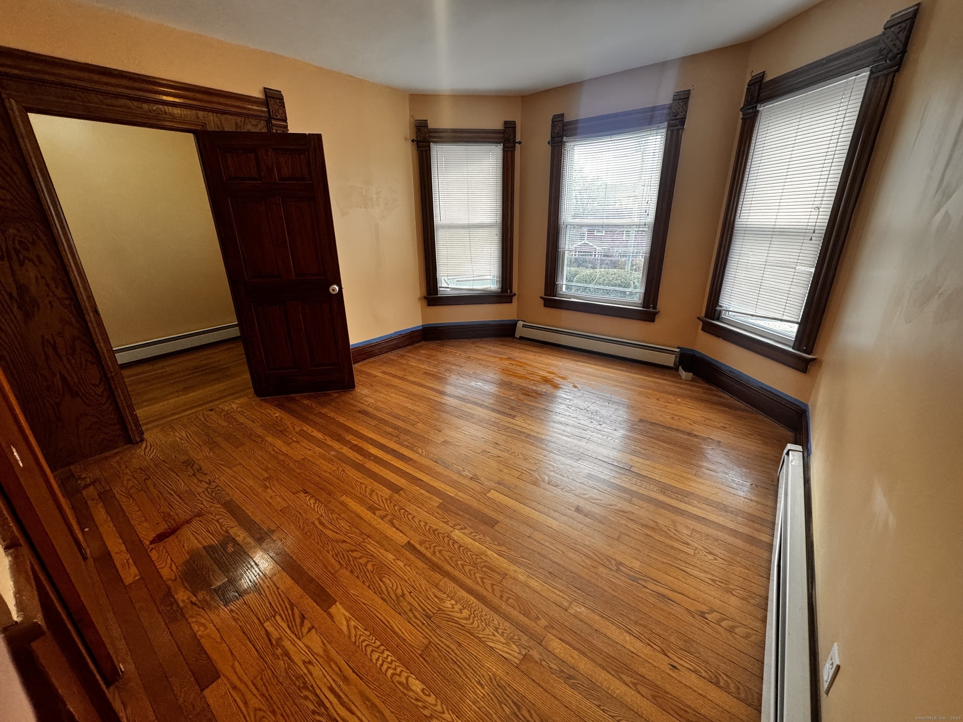181 High Street, Unit 2 Naugatuck, CT 06770 - Photo 5 of 14 a view of an empty room with wooden floor and a window