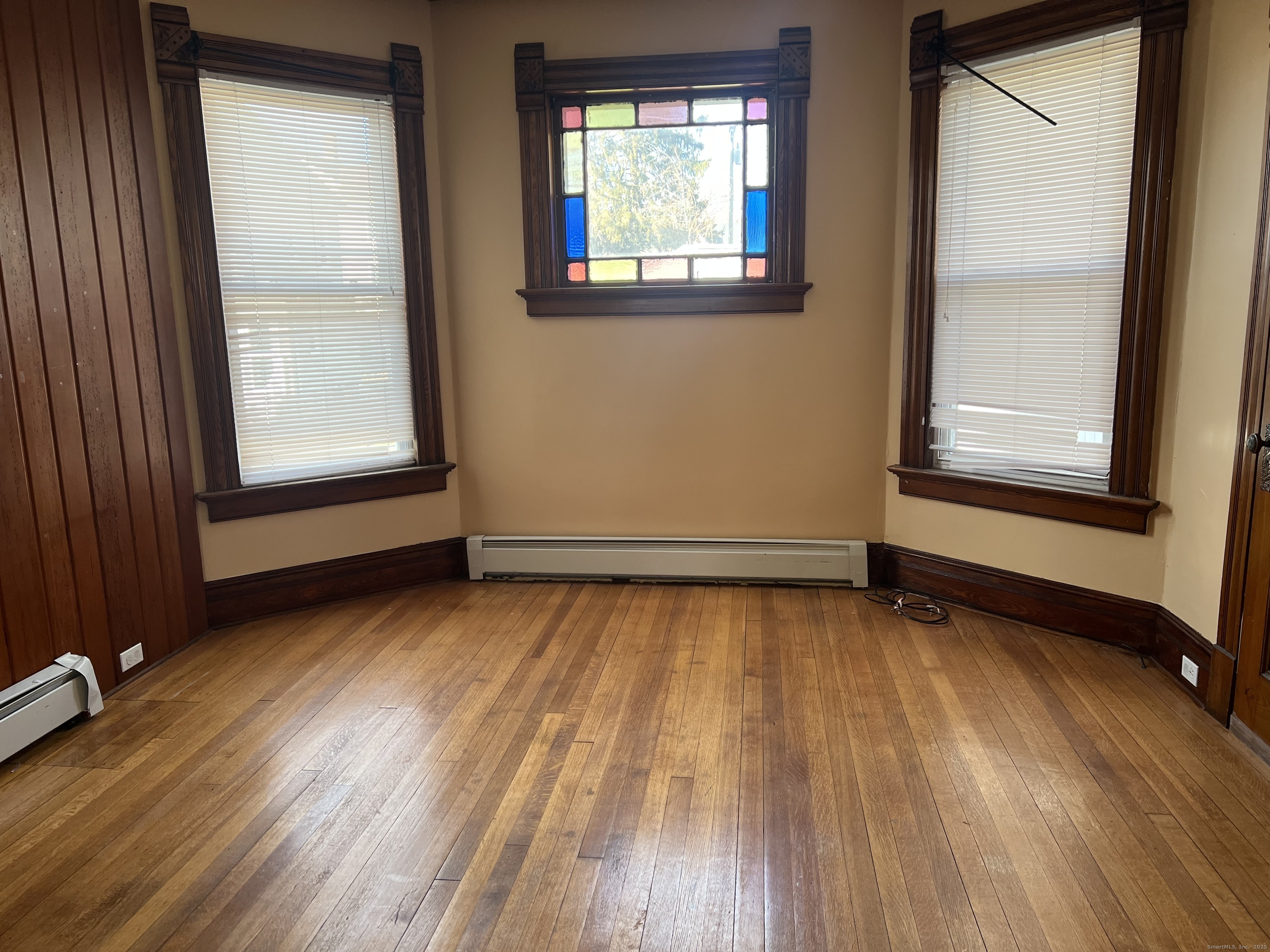 181 High Street, Unit 2 Naugatuck, CT 06770 - Photo 8 of 14 an empty room with wooden floor and windows