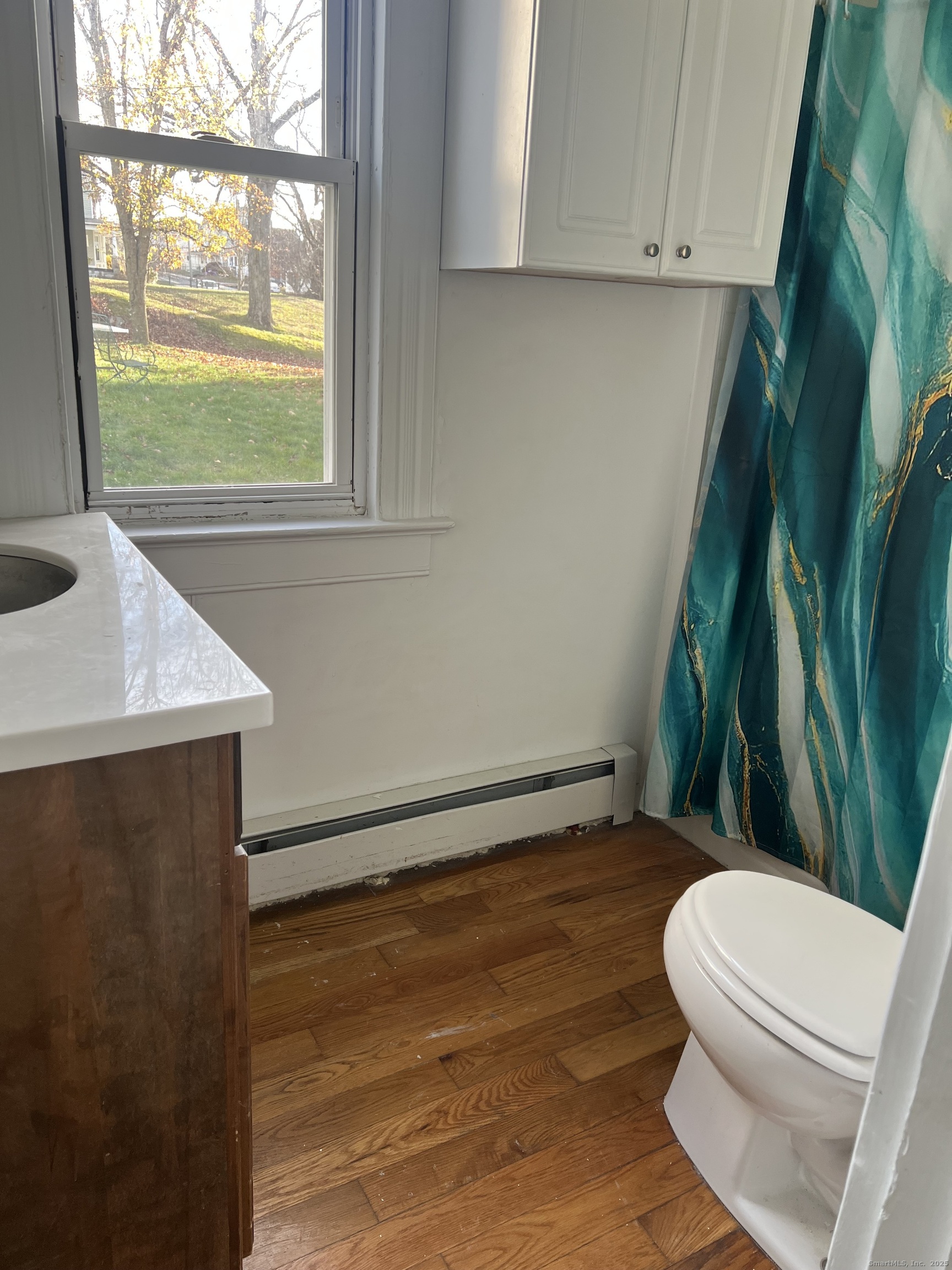 181 High Street, Unit 2 Naugatuck, CT 06770 - Photo 9 of 14 a bathroom with a toilet a sink and a window
